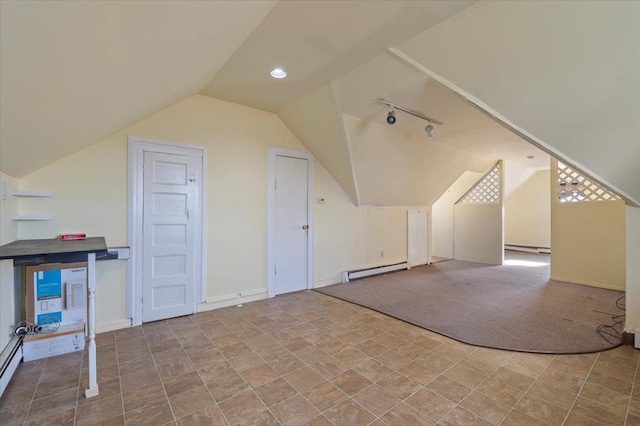 additional living space with lofted ceiling, a baseboard heating unit, and light colored carpet