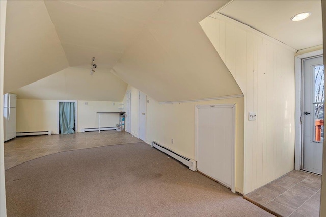 bonus room with a baseboard radiator, vaulted ceiling, and light carpet