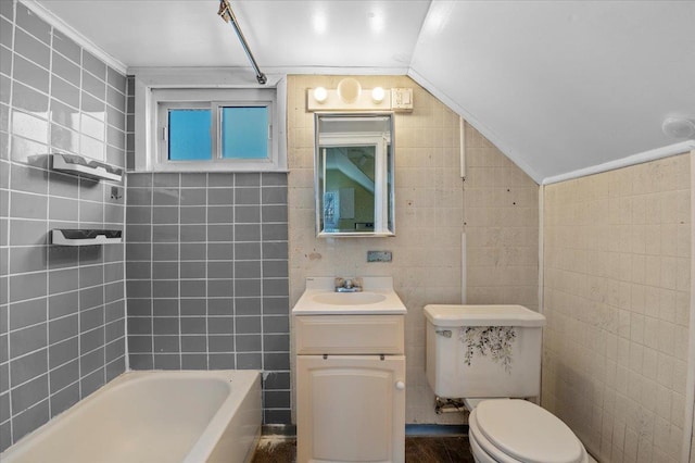 bathroom featuring lofted ceiling, tile walls, vanity, a bath, and toilet