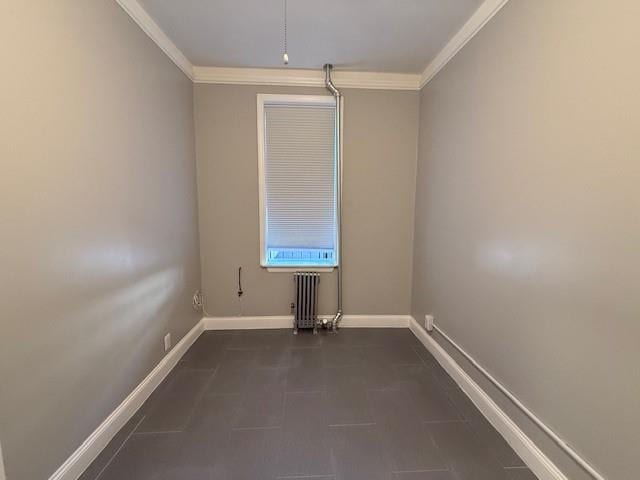 empty room with crown molding and radiator heating unit