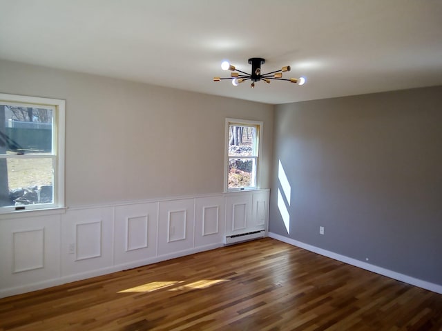 129 Franklin Ave, Monroe, NY 10950 - spare room featuring a baseboard radiator and dark hardwood / wood-style floors