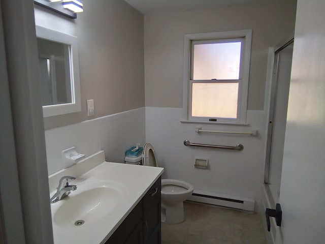 129 Franklin Ave, Monroe, NY 10950 - bathroom featuring a baseboard radiator, vanity, toilet, and tile walls