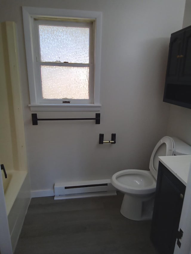 129 Franklin Ave, Monroe, NY 10950 - bathroom with toilet, wood-type flooring, a baseboard radiator, vanity, and a bathing tub