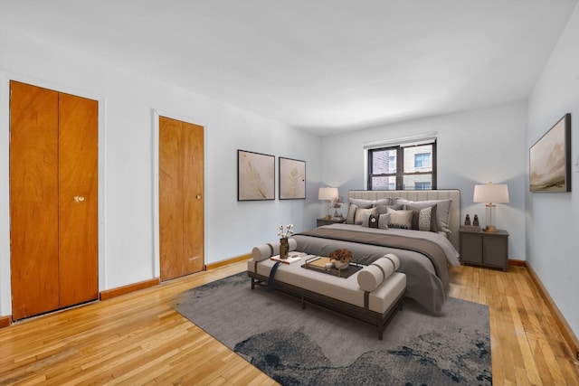 bedroom with light wood-style flooring and baseboards