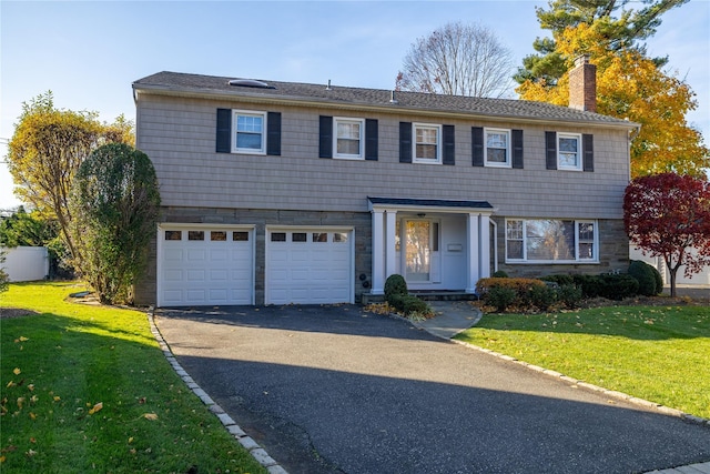 view of front facade featuring a garage and a front lawn