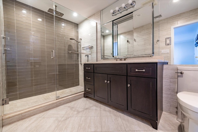 bathroom with walk in shower, tile patterned floors, toilet, tile walls, and vanity