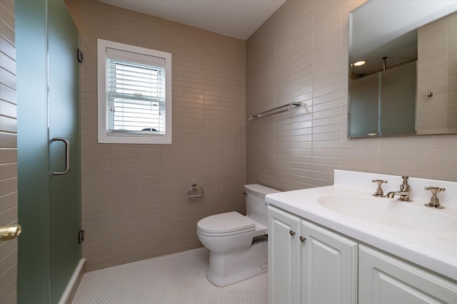 bathroom featuring toilet, an enclosed shower, tile walls, vanity, and tile patterned flooring