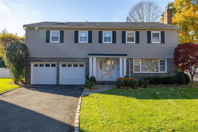 view of front of house featuring a garage and a front lawn