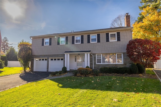 view of front of house with a garage and a front yard