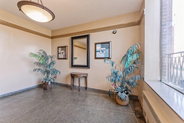 interior space featuring radiator and baseboards