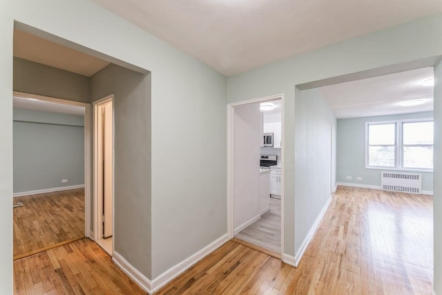 hall featuring radiator and light wood-type flooring