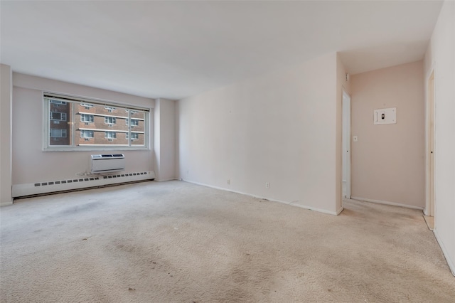 carpeted empty room with a wall mounted air conditioner and baseboard heating