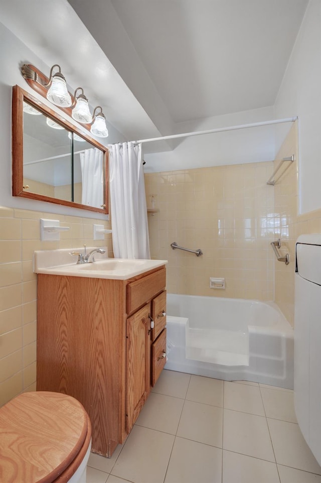 full bathroom featuring washer / clothes dryer, tile walls, tile patterned flooring, vanity, and shower / tub combo