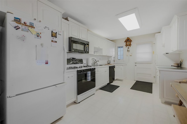 kitchen featuring white cabinetry and black appliances