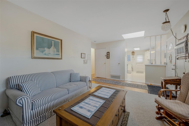 living room with a skylight and a wall mounted AC