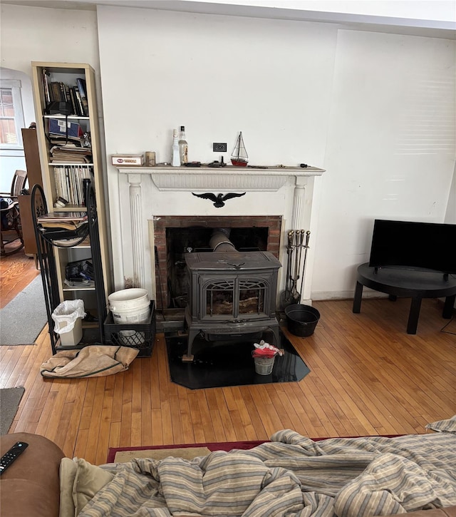 living room featuring hardwood / wood-style flooring and a wood stove