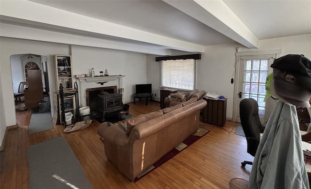 living room with hardwood / wood-style flooring and beam ceiling