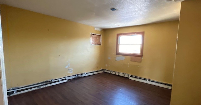 spare room with dark wood-type flooring and a textured ceiling