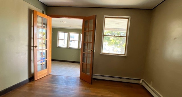 entryway with wood-type flooring, french doors, and baseboard heating