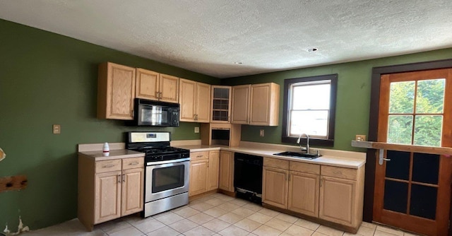 kitchen featuring sink, black appliances, a textured ceiling, and light brown cabinets