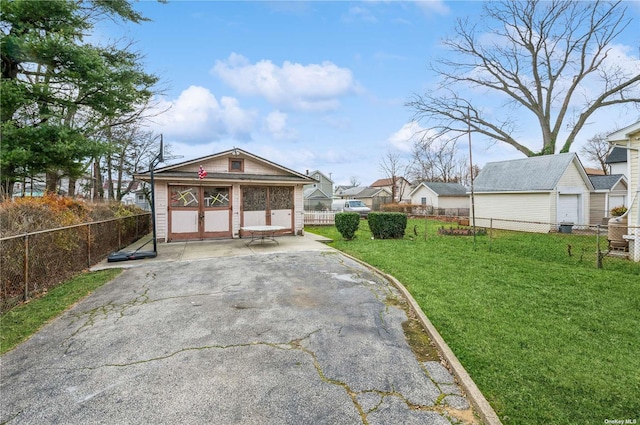 view of yard featuring a garage and an outbuilding