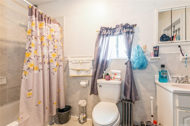 full bathroom featuring toilet, tile walls, radiator heating unit, vanity, and shower / bath combo