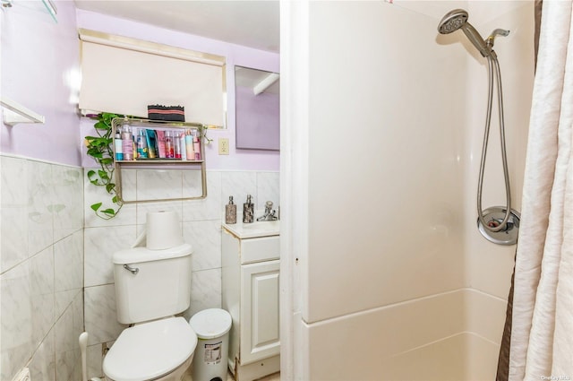 bathroom featuring tile walls and toilet