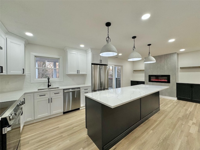 kitchen featuring white cabinetry, stainless steel appliances, and sink