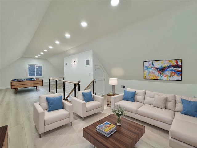 living room featuring vaulted ceiling and light hardwood / wood-style floors