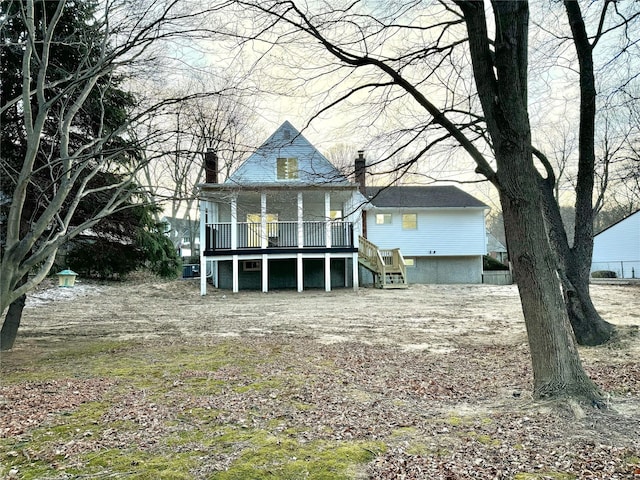 rear view of house featuring a wooden deck