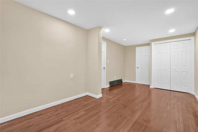 unfurnished bedroom featuring hardwood / wood-style flooring and a closet