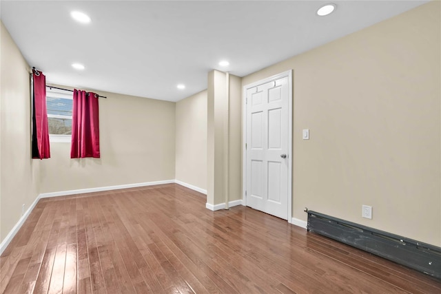 empty room with hardwood / wood-style floors