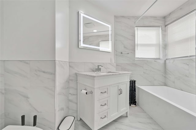 bathroom with vanity and tile walls