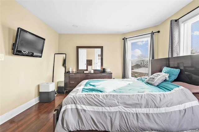 bedroom with dark wood-type flooring