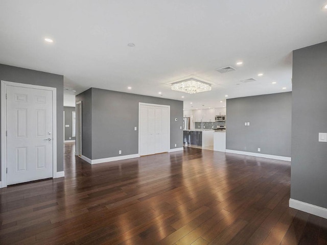 unfurnished living room with dark hardwood / wood-style floors