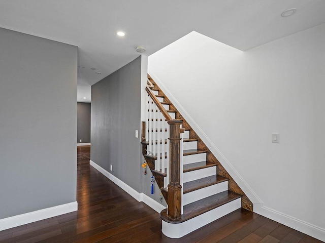 staircase with hardwood / wood-style flooring