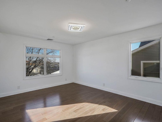 spare room with dark wood-type flooring