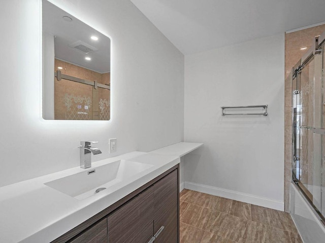 bathroom featuring vanity and shower / bath combination with glass door