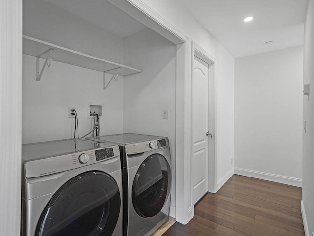 laundry area with dark hardwood / wood-style floors and separate washer and dryer