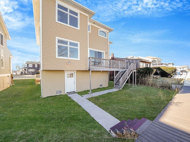 rear view of property with a lawn and a deck