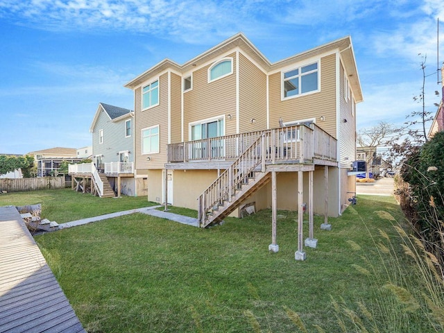 back of house with a yard and a deck