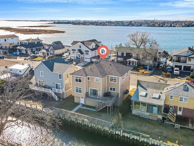 aerial perspective of suburban area featuring a nearby body of water