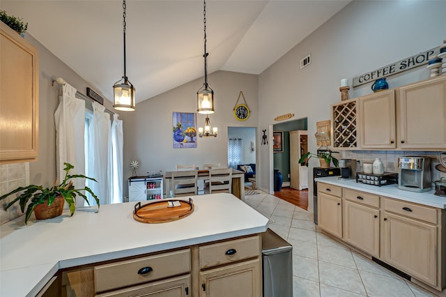 kitchen with pendant lighting, lofted ceiling, light tile patterned flooring, and decorative backsplash