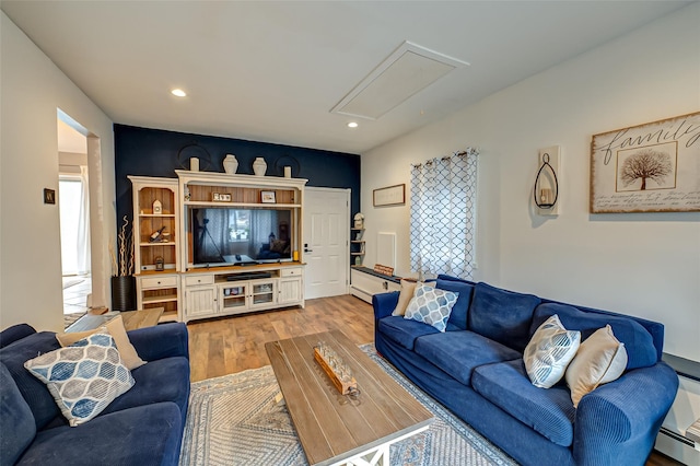 living room featuring light hardwood / wood-style flooring and a baseboard heating unit