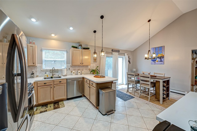 kitchen featuring sink, light brown cabinets, kitchen peninsula, pendant lighting, and stainless steel appliances