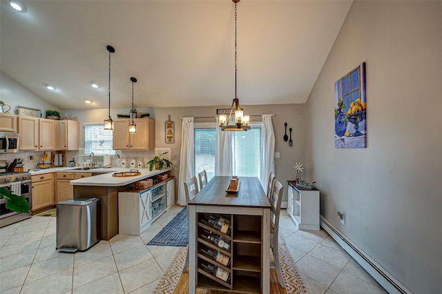 kitchen featuring light brown cabinetry, decorative light fixtures, a baseboard radiator, and appliances with stainless steel finishes