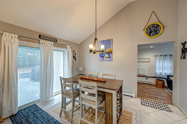 dining room with high vaulted ceiling, a baseboard heating unit, light tile patterned floors, and an inviting chandelier