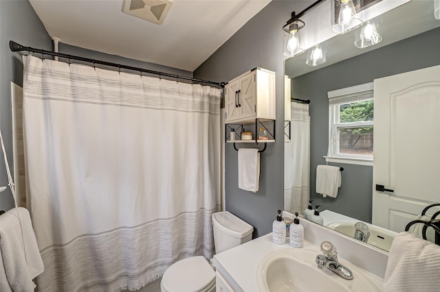 bathroom with vanity, toilet, and a shower with shower curtain