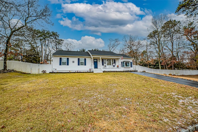 ranch-style home with a porch and a front lawn