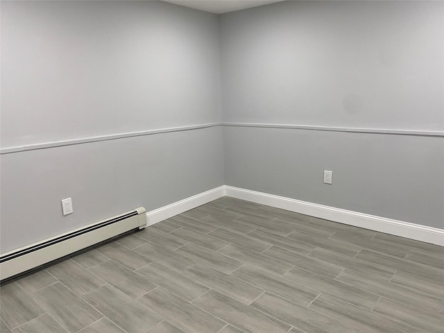 unfurnished room with a baseboard radiator